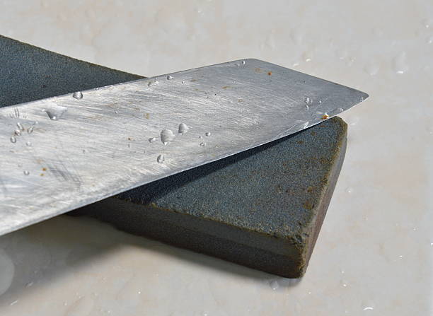 istock kitchen knife blade and whetstone on tile floor 495185590