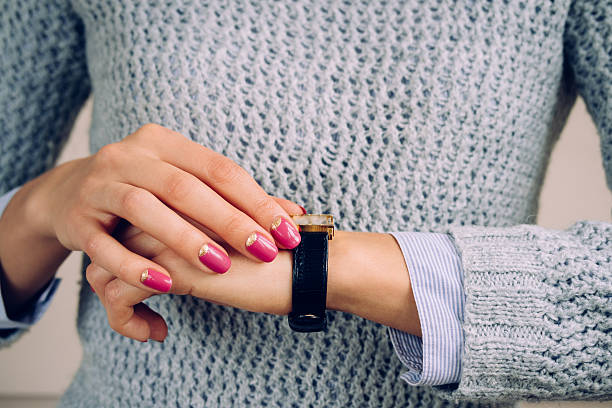 Gold watch with a leather strap on a female hand