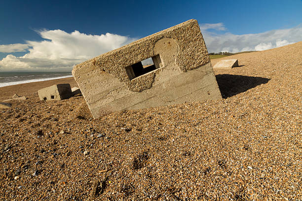 istock World War Two Pillbox sinking into pebbled beach, Chesil Bank 495187487