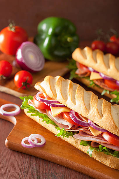 istock long baguette sandwich with ham cheese tomato lettuce 495188216