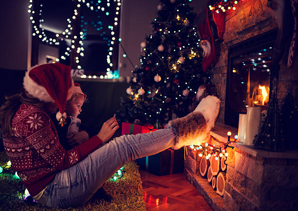 istock Mother and son by a fireplace on Christmas night 495188232
