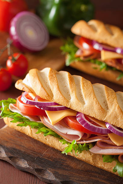istock long baguette sandwich with ham cheese tomato lettuce 495188264