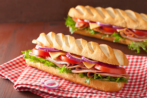 istock long baguette sandwich with ham cheese tomato lettuce 495188308