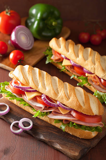 istock long baguette sandwich with ham cheese tomato lettuce 495188352