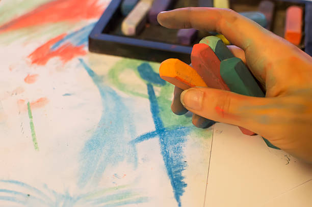 istock young women hand draw with colored chalk 495188589