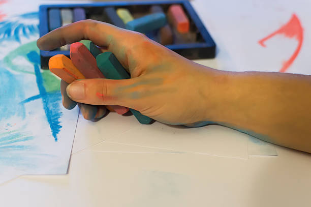 istock young women hand draw with colored chalk 495188605