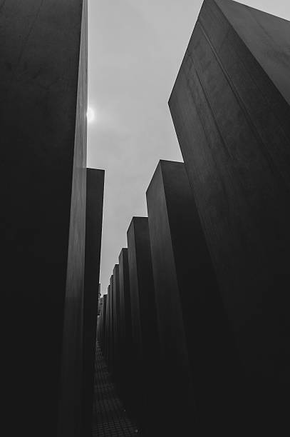 Holocaust Memorial Berlin, Germany - May 6, 2014: The Holocaust Memorial in Berlin, with overall 2,711 concrete blocks. It reminds of the murdered Jews in Europe. berlino stock pictures, royalty-free photos & images
