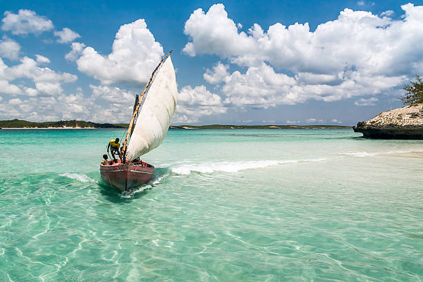 Traditional fishing boat Antsiranana, Madagascar - November 19, 2008: Fishermen in a traditional fishing boat in the Emerald Sea of Antsiranana (Diego Suarez), north of Madagascar. madagascar beach photos stock pictures, royalty-free photos & images