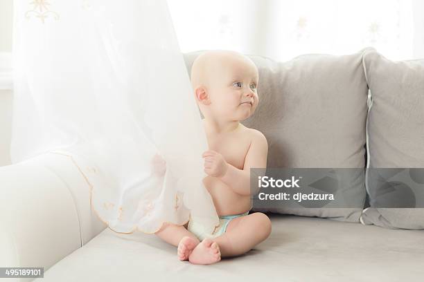 Aby Sitting On The Sofa In Living Room Stock Photo - Download Image Now - 6-11 Months, Baby - Human Age, Beauty