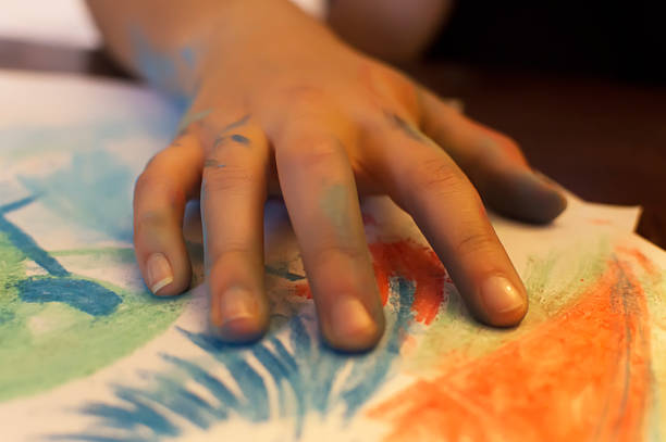 istock young women hand draw with colored chalk 495189261
