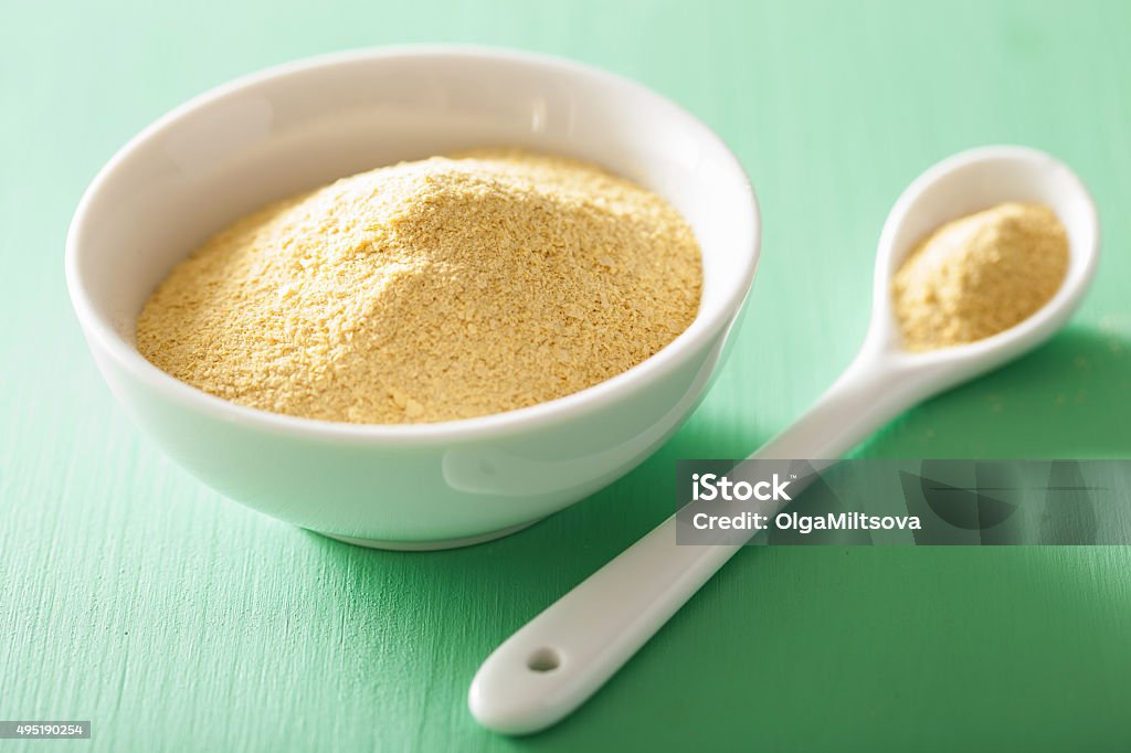 vegan nutritional yeast flakes in bowl Yeast Stock Photo