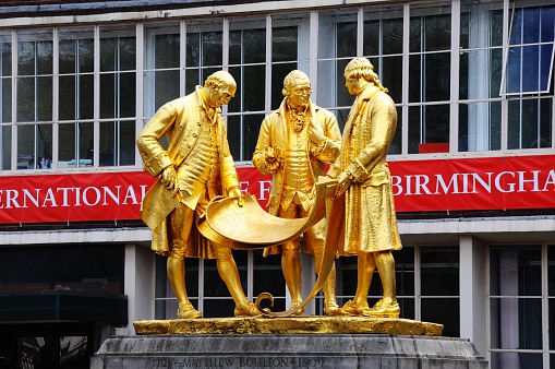 Birmingham, United Kingdom - May 14, 2014:Statue of Matthew Boulton, James Watt, and William Murdoch by William Bloye along Broad Street, Birmingham, England, UK, Western Europe.