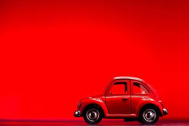 İzmir, Turkey - May 21, 2014: Toy Volkswagen Beetle, shooted red colored background, macro shot.