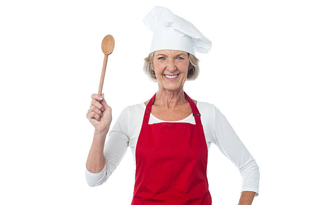 istock Happy aged chef holding wooden spoon 495193195