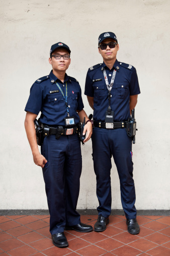 Singapore, Singapore - February 10, 2014: Police on patrol in the Little India neighbourhood of Singapore. Singapore's crime rate hit a 30 year low in 2013 with total crime cases falling 4.3 per cent.