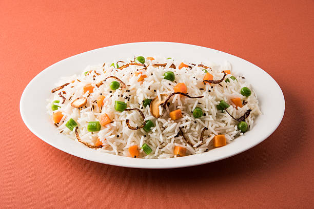 istock Indian Pulav or vegetables rice or veg biryani  orange background 495199308