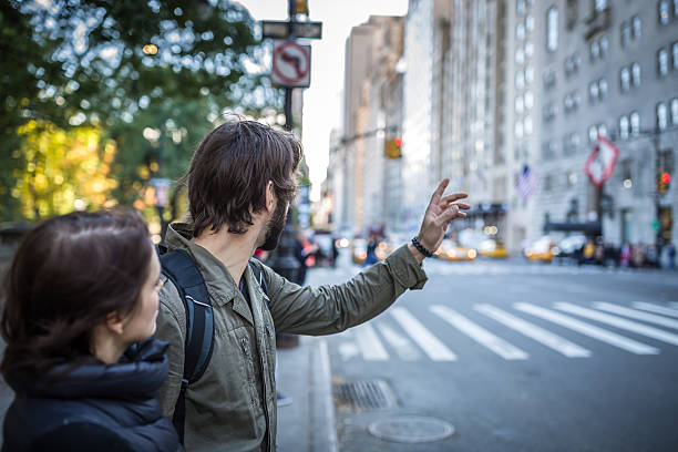 istock Couple Hailing a Cab, Uber in New York 495200370