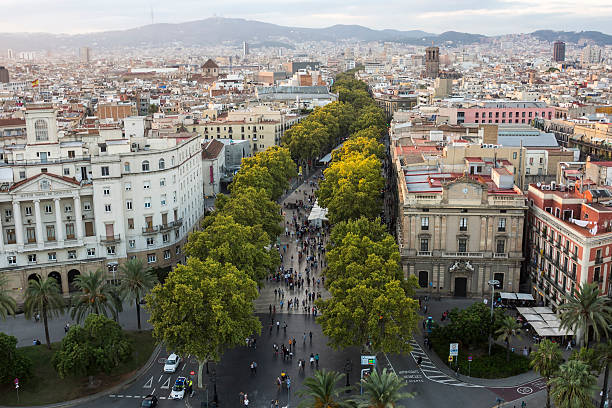 La Rambla Street in Barcelona at Sunset La Rambla Street is the most popular touristic place in Barcelona. A view from the Columbus Monument. la rambla stock pictures, royalty-free photos & images