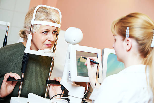 Female ophthalmologist or optometrist at work Optometry concept. female optometrist optician doctor examines eyesight of female patient in eye ophthalmological clinic  dilation stock pictures, royalty-free photos & images