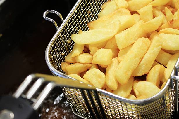istock french fries and fish in frying baskets 495208941