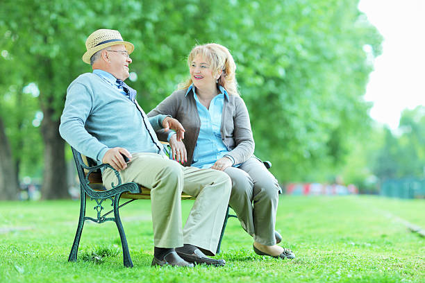 istock Elderly couple relaxing on a bench in park 495210929