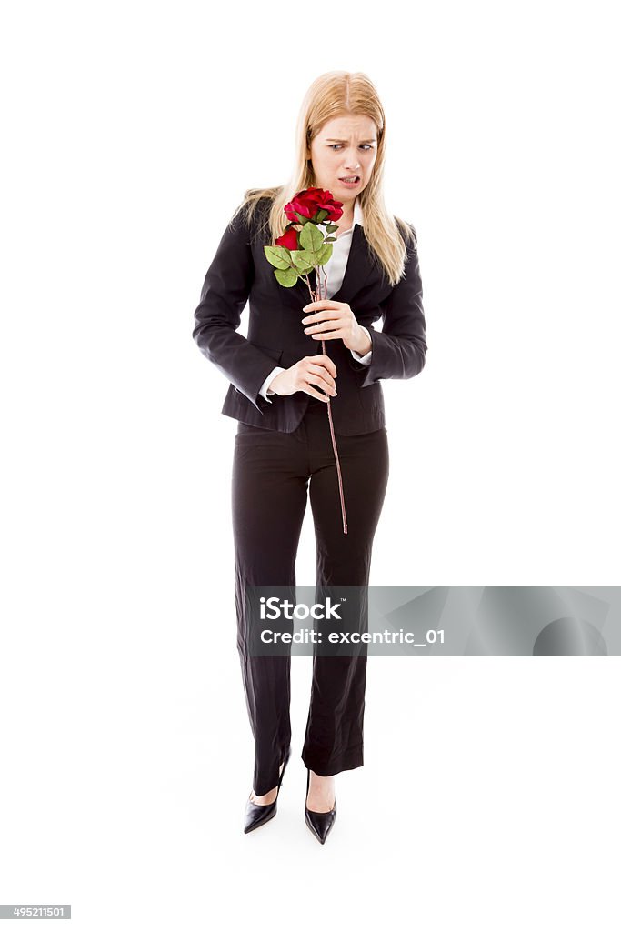 Disappointed businesswoman holding a red rose flower 25-29 Years Stock Photo