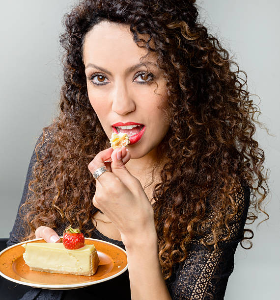 istock Beautiful woman eating cheese cake 495211521