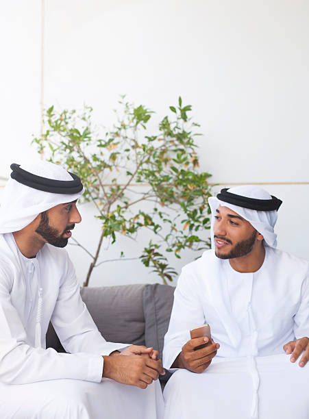 istock Two Emirati Men Talking in a Shopping Mall Cafe 495213526