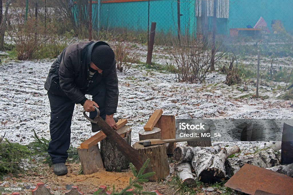 Worker sawing boards in a country house 2015 Stock Photo