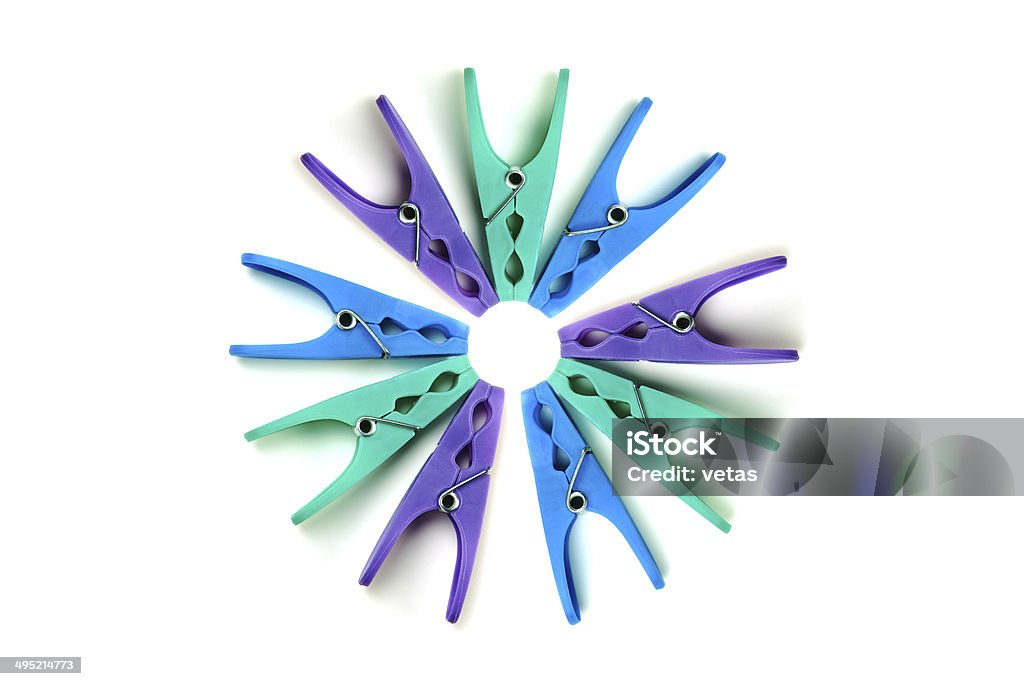 Plastic clothes pegs on a white background Coloured plastic clothes pegs on a white background Blue Stock Photo