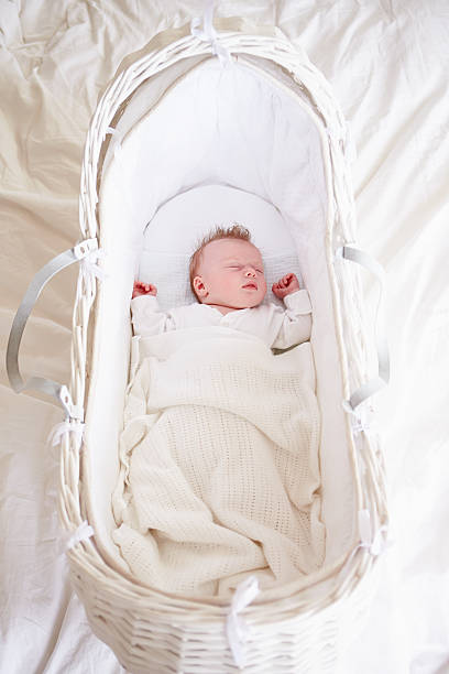Newborn Baby Girl Sleeping In Cot Newborn Baby Girl Sleeping In Cot moses basket stock pictures, royalty-free photos & images