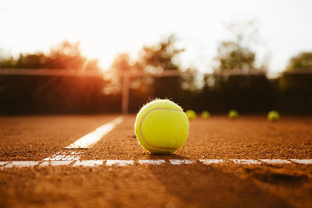 Tennis ball on a clay court stock photo