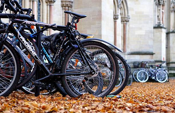 Cambridge, UK - October 31 2015: Student bicycles parked on a rack outside St John's College, Cambridge, on a sunny autumn afternoon. Cycling is the most common form of transportation for students at Cambridge University.