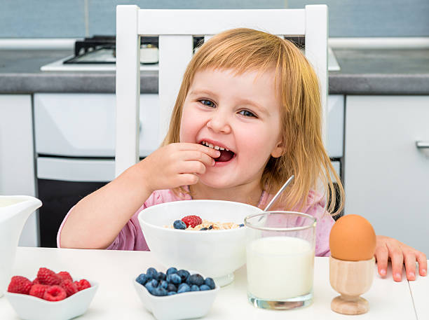 istock little girl having healthy breakfast 495218498