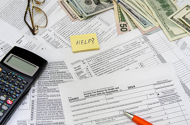istock taxation concept: form with calculator, money, pen 495226030