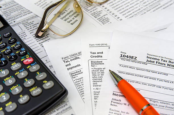 istock taxation concept: form with calculator, money, pen 495226060