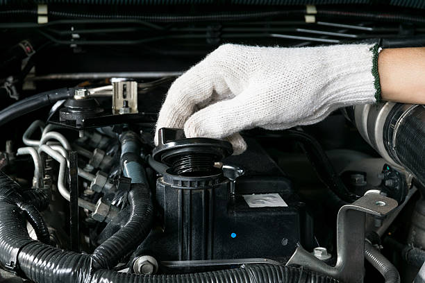 istock mechanic is opening the oil cap from a car engine. 495228284