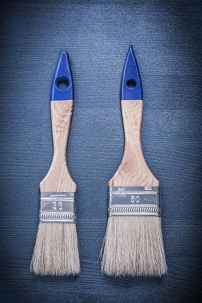 istock Paintbrushes on wooden board construction concept 495229652