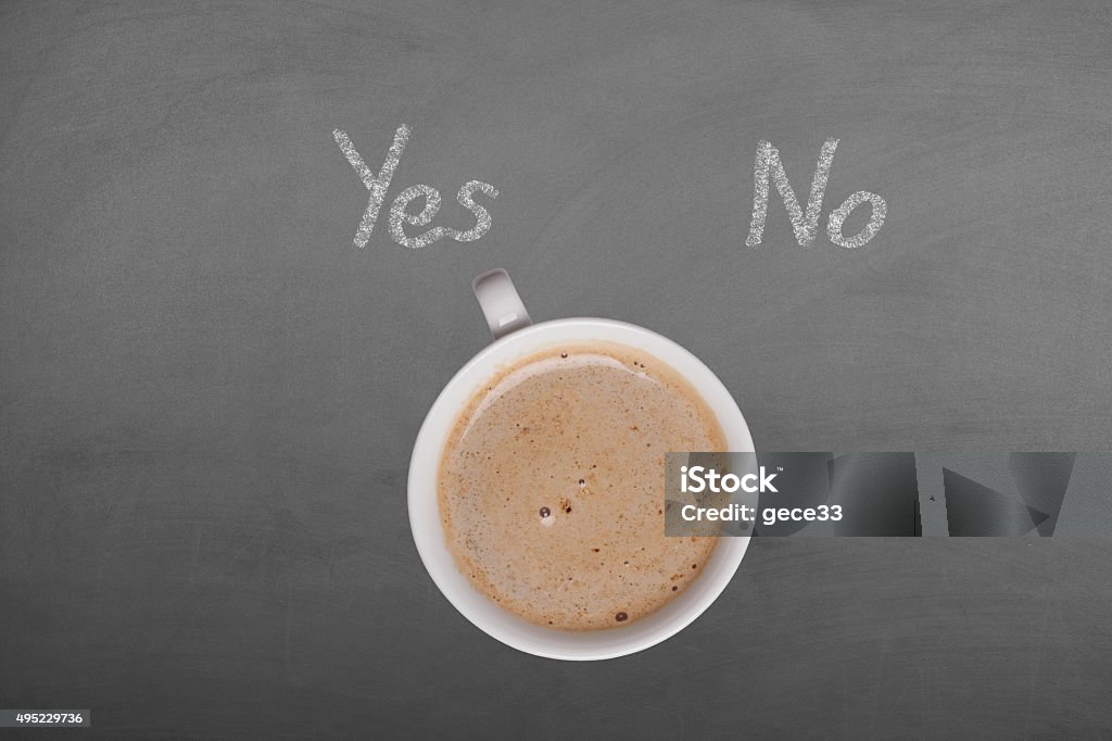 Coffee cup on blackboard with yes no 2015 Stock Photo