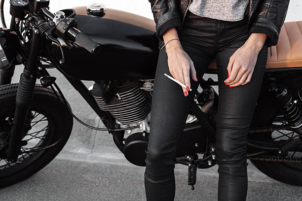 istock Young woman on motorcycle smoking sigarette 495229908