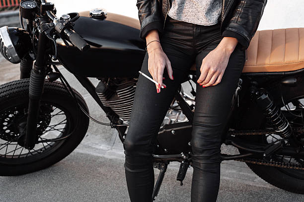 istock Young woman on motorcycle smoking sigarette 495230024