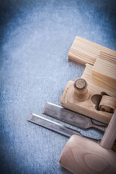 istock Wooden shaving plane hammer stud flat chisels on metallic backgr 495231358