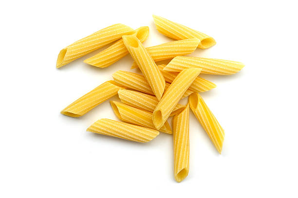 Penne pasta Penne pasta uncooked white background noodles photos stock pictures, royalty-free photos & images