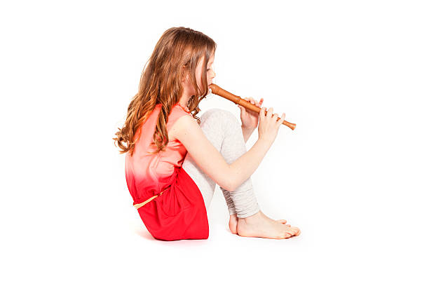 istock young sitting girl playing soprano recorder 495235301