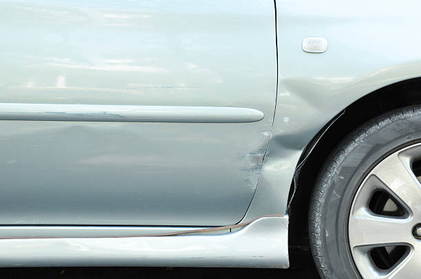 istock Damaged car with a dent near the wheel 495235471