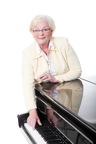 istock older lady in yellow near piano 495235745