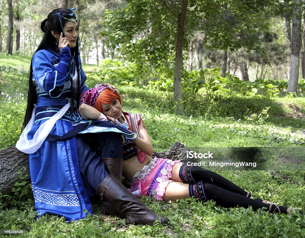 PEOPLE: girls cosplay game character heroine in traditional clothing, Beijing PEOPLE: girls cosplay pc game character heroine in traditional clothing, one lean on the other's keens, Beijing, China 20-29 Years Stock Photo