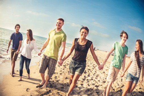 Group of multi-ethnic friends on the beach, happiness and relax on vacation.
