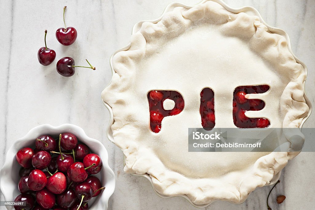 Unbaked Cherry Pie An overhead close up shot of an unbaked cherry pie with the word PIE cut out on the crust. Baking Sheet Stock Photo