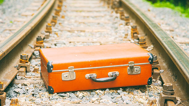 istock old brown suitcase on the railway 495236907
